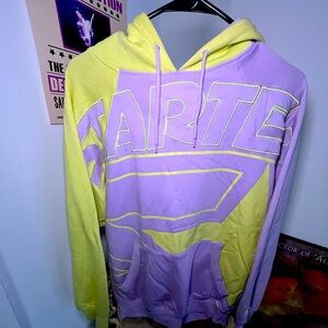 Light green-yellow/purple Starter hoodie.